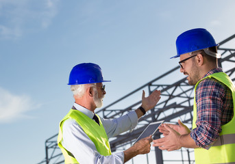 Engineer and construction worker at building site