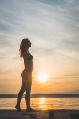 Young attractive girl model silhouette on the beach