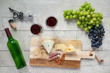 Red Wine with Cheese and Grapes Background