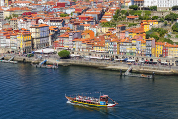 Fototapeta na wymiar Traditional boats with barrels of wine, on the Douro River in the Portuguese city of Porto.