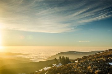 Sea of the clouds captured on the highest mountain called Snezka in Czech republic during the winter sunrise.