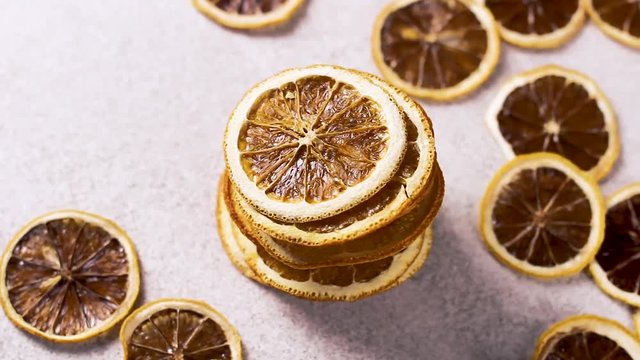 Dried orange rotating on white tecture surface. Close up.