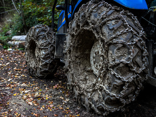Fototapeta na wymiar heavy tractor tire with chains