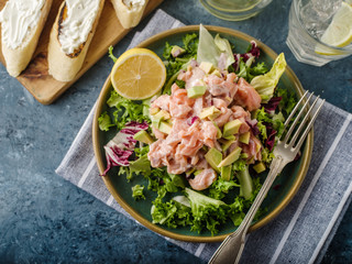 Ceviche is a traditional dish from Peru. Salmon marinated in lemon with fresh lettuce, avocado and onions