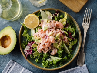 Ceviche is a traditional dish from Peru. Salmon marinated in lemon with fresh lettuce, avocado and onions