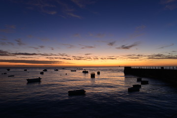 Fototapeta na wymiar La Rocque harbour, Jersey, U.K. Autumn sunrise and a high tide.