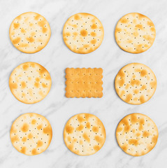 Crackers and biscuits on marble background