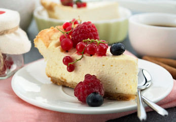 Homemade cheesecake with fresh berries ( raspberry, red currant, blueberry). Perfect  dessert with summer taste for winter breakfast. Closeup.
