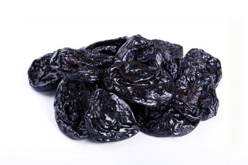 Dry plums on white isolate.