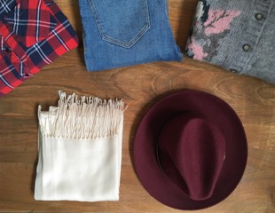 Woman winter clothes set on wooden table