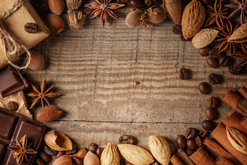 Texture spilling coffee beans, chocolate, cinnamon and cloves. Top view. Copy space.