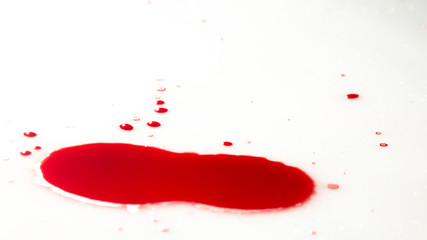 drops of red blood on white paper