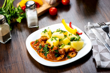 pork goulash served with boiled potatoes