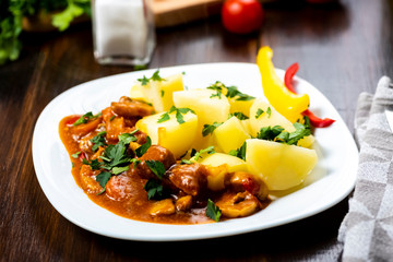 pork goulash served with boiled potatoes