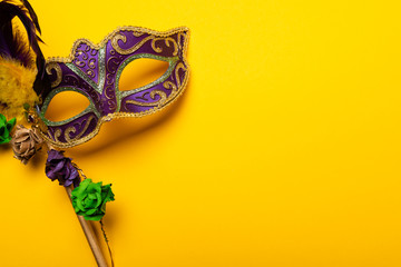 Colorful Mardi Gras mas on a yellow background