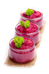 Beetroot puree in glass jars isolated on white