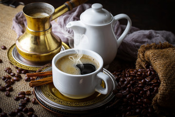 Black coffee in a cup on old background