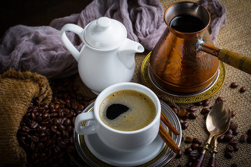 Black coffee in a cup on old background