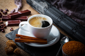Black coffee in a cup on old background