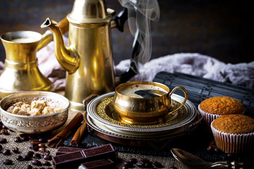 Black coffee in a cup on old background