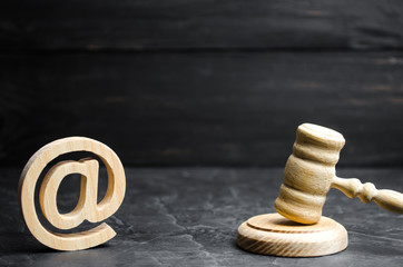 Judge's hammer and email address. The concept of legal proceedings for the seizure of rights to use...
