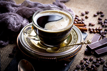 Obraz na płótnie Canvas Black coffee in a cup on old background