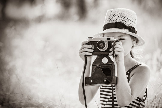 photo of the beautiful girl taking photos with her camera . Image in black and white color style