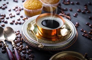 Black coffee in a cup on old background