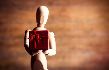 photo of the beautiful gestalta with gift on the brown wooden background