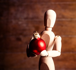 photo of the beautiful gestalta with red bauble on the brown wooden background