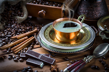 Black coffee in a cup on old background