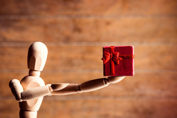 photo of the beautiful gestalta with gift on the brown wooden background