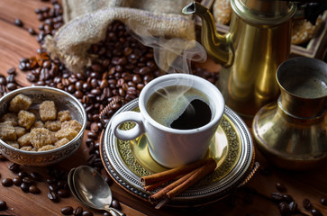 Black coffee in a cup on old background