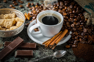 Black coffee in a cup on old background