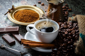 Black coffee in a cup on old background