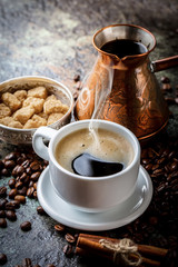 Black coffee in a cup on old background