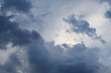 Naklejka na ściany i meble Beautiful dark clouds slowly flying in the sky