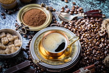Black coffee in a cup on old background