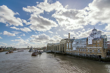 Beautiful buildings with particular architecture on the Thames sides with ships and boats floating on the water. Travel planning for vacation