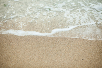 Fototapeta na wymiar Wave on the beach sand