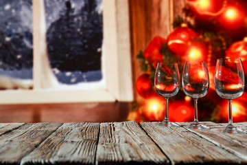 Glass wine glasses on a wooden board in a beautiful winter environment   