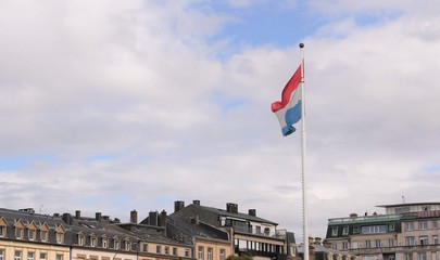 The flag of Luxembourg flying over the  old town of Luxembourg City, Luxembourg, with copy space.