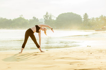 girl doing sport on the beach