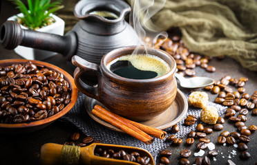 Black coffee in a cup on old background