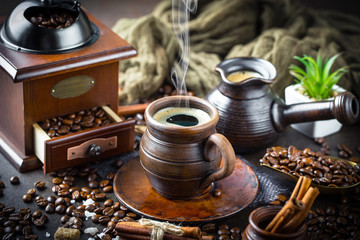 Black coffee in a cup on old background