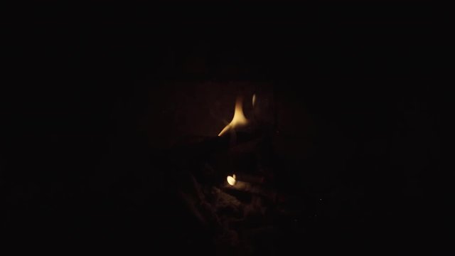 Fading Remnants of a Fire in a Brick Fireplace