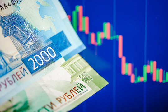 The concept of the fall of the ruble. Two Thousand rubles bill on a blue chart.