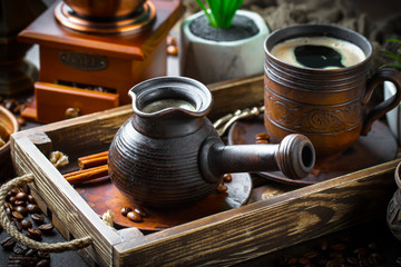 Black coffee in a cup on old background