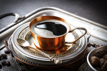 Black coffee in a composition with kitchen accessories