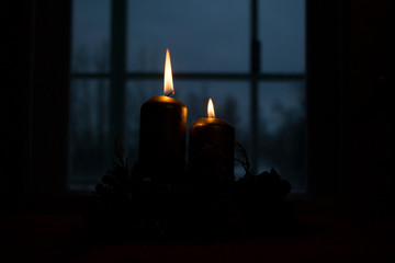 candle in the dark near the window